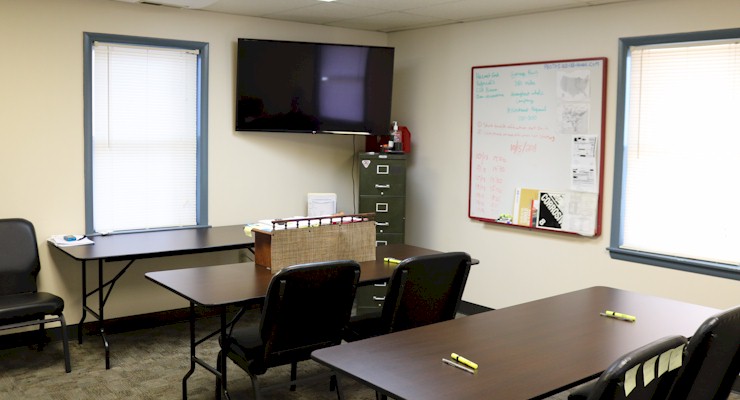 Barr-Nunn Manchester, PA truck terminal building showing driver training room desks, chairs, whiteboard, and television